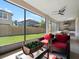 Enjoy outdoor living on this screened-in patio with a ceiling fan, chairs, and outdoor kitchen access at 14172 Hutchinson St, Winter Garden, FL 34787