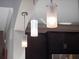 Modern kitchen with frosted glass pendant lights and dark wood cabinets for a sleek, contemporary design at 14172 Hutchinson St, Winter Garden, FL 34787