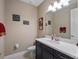 Stylish powder room with dark vanity, white countertop, and fun wall decor and artwork at 14172 Hutchinson St, Winter Garden, FL 34787