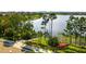 Scenic waterfront featuring a lake, wooden dock, and lush landscaping with walking paths at 14172 Hutchinson St, Winter Garden, FL 34787