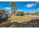 Fenced backyard with green grass and partial view of the house, offering a sense of security and outdoor space at 1607 India Palm Dr, Edgewater, FL 32132