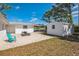 Backyard featuring a patio, shed, and well-maintained lawn, creating a versatile and enjoyable outdoor area at 1607 India Palm Dr, Edgewater, FL 32132