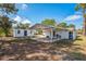 Backyard with a covered patio area, shed, and ample space for entertaining at 1607 India Palm Dr, Edgewater, FL 32132