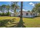 Sprawling backyard featuring mature trees and a well-maintained lawn at 1607 India Palm Dr, Edgewater, FL 32132