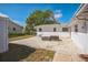 Backyard patio with brick pavers, offering a relaxing outdoor space with a fire pit, and blue chair at 1607 India Palm Dr, Edgewater, FL 32132