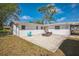 Backyard patio with brick pavers and a modern fire pit, creating an inviting outdoor entertainment space at 1607 India Palm Dr, Edgewater, FL 32132