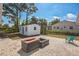 Backyard featuring a patio, shed, and firepit, creating a versatile and enjoyable outdoor area at 1607 India Palm Dr, Edgewater, FL 32132
