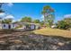 Spacious backyard featuring a covered patio, shed, and plenty of room for outdoor living at 1607 India Palm Dr, Edgewater, FL 32132