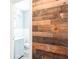 The bathroom features a reclaimed wood wall, and updated fixtures at 1607 India Palm Dr, Edgewater, FL 32132