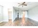 Spacious bedroom with wood flooring, ceiling fan, multiple doors, and a closet at 1607 India Palm Dr, Edgewater, FL 32132