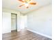 Bright bedroom featuring hardwood floors, closet, and a ceiling fan at 1607 India Palm Dr, Edgewater, FL 32132
