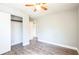 Bright bedroom with hardwood floors, closet with open shelving, and a doorway at 1607 India Palm Dr, Edgewater, FL 32132