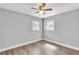 Bedroom featuring hardwood floors, ceiling fan, and two windows at 1607 India Palm Dr, Edgewater, FL 32132