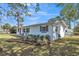 This is a shot of the exterior with landscaping and white painted brick and a walkway for easy access at 1607 India Palm Dr, Edgewater, FL 32132