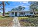 This is a nice front shot of this house showing the walkway, landscaping, and the address above the door at 1607 India Palm Dr, Edgewater, FL 32132