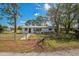 Lovely front exterior with white painted brick, landscaping and walkway to this single story home at 1607 India Palm Dr, Edgewater, FL 32132