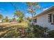 Well-manicured front yard with lush landscaping surrounding a brick-paved garden at 1607 India Palm Dr, Edgewater, FL 32132