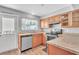 Well-lit kitchen features wood cabinets, stainless steel appliances, and laminate countertops at 1607 India Palm Dr, Edgewater, FL 32132