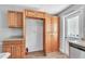 This kitchen features wood cabinets, granite countertops, and a convenient pantry area at 1607 India Palm Dr, Edgewater, FL 32132