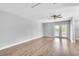 Bright and airy living room with hardwood floors and a view to the backyard at 1607 India Palm Dr, Edgewater, FL 32132