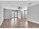 Spacious living room with wood flooring, modern ceiling fan, and glass patio doors at 1607 India Palm Dr, Edgewater, FL 32132