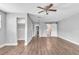 Spacious living room featuring hardwood floors, ceiling fan and fresh paint at 1607 India Palm Dr, Edgewater, FL 32132