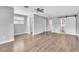 Bright main bedroom featuring wood flooring, a ceiling fan, and a barn door to the bathroom at 1607 India Palm Dr, Edgewater, FL 32132
