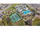 Aerial view showcasing community amenities, including a pool, tennis courts, and playground at 1696 Tohoqua Blvd, Kissimmee, FL 34744