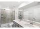 Elegant bathroom featuring a double sink vanity, tiled shower, and modern fixtures at 1696 Tohoqua Blvd, Kissimmee, FL 34744