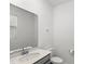 Well-lit half bathroom featuring a modern sink and a convenient layout at 1696 Tohoqua Blvd, Kissimmee, FL 34744