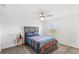 Bright bedroom with a ceiling fan, a window letting in natural light, and a comfortable-looking bed at 1696 Tohoqua Blvd, Kissimmee, FL 34744