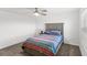 Cozy bedroom features soft carpet and a comfortable bed with colorful striped blanket at 1696 Tohoqua Blvd, Kissimmee, FL 34744