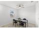 Simple dining area featuring a dark wood table, black chairs, and a ceiling fan at 1696 Tohoqua Blvd, Kissimmee, FL 34744