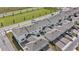 Aerial view showcasing modern townhomes with attached garages and small patio spaces in a well-planned community at 1696 Tohoqua Blvd, Kissimmee, FL 34744