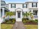Two-story townhome with a neutral exterior, manicured landscaping, and a welcoming front entry at 1696 Tohoqua Blvd, Kissimmee, FL 34744