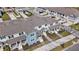 Aerial view of townhomes with covered front porches and well-manicured landscaping in a suburban neighborhood at 1696 Tohoqua Blvd, Kissimmee, FL 34744