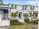 Inviting townhome exterior featuring a well-maintained lawn and charming entryway at 1696 Tohoqua Blvd, Kissimmee, FL 34744