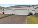 Spacious three-car garage with brick-paved driveway, offering ample parking and curb appeal at 1696 Tohoqua Blvd, Kissimmee, FL 34744