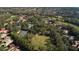 Picturesque aerial scene of homes, golf course, and a pool within a vibrant, tree-filled neighborhood at 1707 Stetson Ct, Longwood, FL 32779
