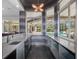 Chic bar area with views of the outdoor pool, custom cabinetry, and modern lighting at 1707 Stetson Ct, Longwood, FL 32779