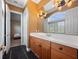Bathroom showcasing a vanity with a sink, large mirror, with access to another room at 1707 Stetson Ct, Longwood, FL 32779