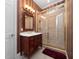 Elegant bathroom featuring a vanity with a traditional design and glass shower doors at 1707 Stetson Ct, Longwood, FL 32779