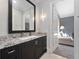 Elegant bathroom featuring a granite countertop, modern fixtures, and access to the living room at 1707 Stetson Ct, Longwood, FL 32779