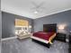Comfortable bedroom with a ceiling fan, gray walls, carpet flooring, and seating near the window at 1707 Stetson Ct, Longwood, FL 32779
