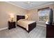 Comfortable bedroom with a ceiling fan, tan walls, carpet flooring, and natural light at 1707 Stetson Ct, Longwood, FL 32779