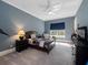 Comfortable bedroom with a ceiling fan, gray walls, carpet flooring, and natural light at 1707 Stetson Ct, Longwood, FL 32779