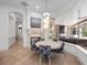 Charming breakfast nook featuring a cozy fireplace and views of the covered pool at 1707 Stetson Ct, Longwood, FL 32779