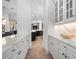 Elegant butler's pantry features white cabinetry, marble countertops, and stylish hardware, with a view into the kitchen at 1707 Stetson Ct, Longwood, FL 32779