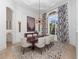 Dining area featuring modern light fixtures, seating for six, and adjacent living area at 1707 Stetson Ct, Longwood, FL 32779