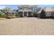 Elegant home featuring a circular driveway, mature landscaping, and a basketball hoop on the side at 1707 Stetson Ct, Longwood, FL 32779
